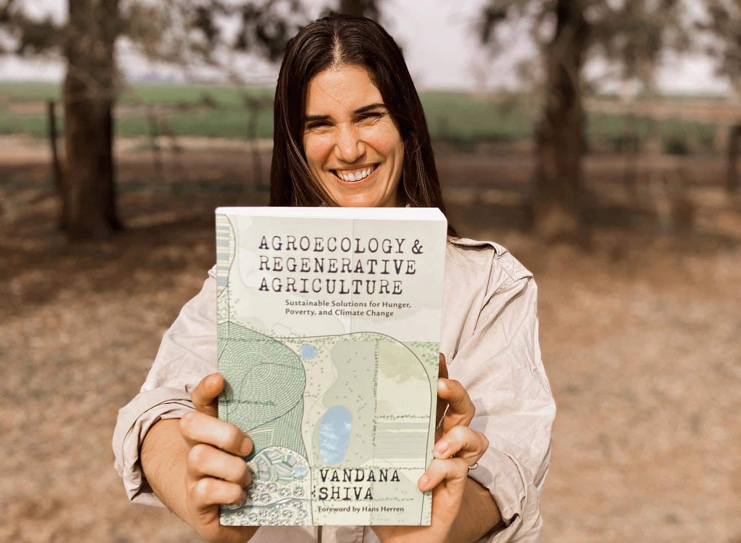 Leticia Pascual holding up Agroecology and Regenerative Agriculture